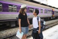 Asian backpack traveler woman with her son on platform at a train station