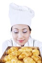 Asian baker smells croissant - isolated Royalty Free Stock Photo