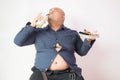 Asian bald fat man with big belly happy in food