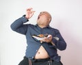 Asian bald fat man with big belly happy in food