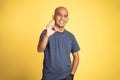 asian bald man showing okay hand gesture with smiling