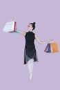 Asian ballerina carrying paper bags