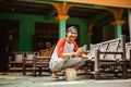 Asian bamboo craftsman smiles at the camera while polishing Royalty Free Stock Photo
