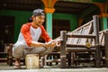 Asian bamboo craftsman using a brush while polishing bamboo chair Royalty Free Stock Photo