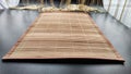 Asian bamboo mat and napkin from yellow bamboo on black surface. Background, texture, frame, copy space, location for Royalty Free Stock Photo