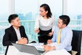 Asian banker counseling man in office