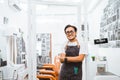 asian barber standing in front of barbershop with smiling face Royalty Free Stock Photo