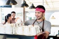 Asian barista preparing espresso for customer couple