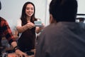 Asian barista served cup of coffee in cafe to customer