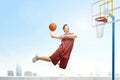 Asian basketball player man jumps in the air with the ball trying to score Royalty Free Stock Photo