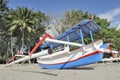 Asian beach scene with outrigger boat