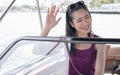 Asian beautiful adorable young woman wearing casual shirt, riding boat or ship for traveling outdoor in summer time, smiling with Royalty Free Stock Photo