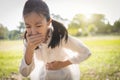 Asian beautiful child girl covered her mouth about to throw up,vomit,puke retch barf,female teenage feel sick from indigestion or Royalty Free Stock Photo