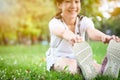 Asian beautiful child girl stretching legs while sitting in park, female teenager warming up before running,exercise in morning,