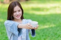 Asian beautiful cute woman in green nature park outdoor with a cup of tea hot drink happy smile Royalty Free Stock Photo