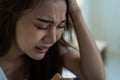 Asian beautiful depression girl crying in tears sit on bed in bedroom. Attractive unhappy young woman feeling sad lonely and upset