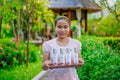 Asian beautiful female spa worker at the spa reception area holding tray with cosmetic product Royalty Free Stock Photo