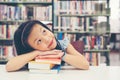 Asian beautiful girl reading books for education and go to school in library. Royalty Free Stock Photo