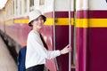 Asian beautiful girl was walking onto the train to travel while the train was parked at the platform