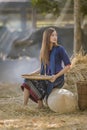 Asian beautiful girl winnowing rice separate between rice and rice husk