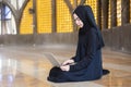 Asian beautiful muslim wearing black hijab women work using laptop computer, Distance online work and working from home.