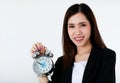 Asian beautiful smiley business woman with long hair wearing formal suit, holding alarm clock and looking to camera with isolated Royalty Free Stock Photo