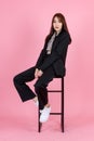 Asian beautiful urban trendy modern fashionable long hair female hipster teenager model in casual black suit with crop top shirt s Royalty Free Stock Photo