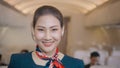 Asian beautiful woman cabin crew is smiling onboard , safety travel , relaxation tourism concept