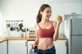 Asian beautiful woman feel happy after lose weight for health in house. Attractive girl feel proud of body and smile, look at Royalty Free Stock Photo