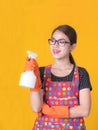 Asian beautiful woman holding a bottle spray  to clean the device and smiling happily to clean the house Royalty Free Stock Photo