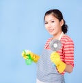 Asian beautiful woman holding a bottle spray  to clean the device and smiling happily to clean the house Royalty Free Stock Photo