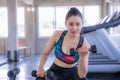 Sian beautiful woman is lifting double in the gym, She smile happily in exercise because it makes her shapely, the concept of exer Royalty Free Stock Photo