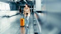 Asian beautiful woman with luggage and walking in airport Royalty Free Stock Photo