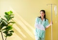 Asian beautiful woman patients standing on yellow background,Happy and smiling,Good attitude,Copy space