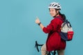 Asian beautiful woman is riding a city bike to work and thumbs up showing great symbol Royalty Free Stock Photo