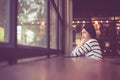 Asian beautiful woman sittiing and looking something out of window at coffee shop cafe,Happy and smiling,Positive thinking Royalty Free Stock Photo