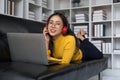 asian beautiful woman smiling at home in headphones listen music at home. Use technology, lifestyle concept Royalty Free Stock Photo