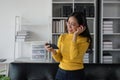 asian beautiful woman smiling at home in headphones listen music at home. Use technology, lifestyle concept Royalty Free Stock Photo