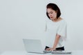 Asian beautiful woman Standing in a white shirt On the front desk, there is a laptop computer placed. Expression There is work Royalty Free Stock Photo