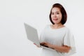 Asian beautiful woman Standing in a white shirt in her hand Holding a laptop computer Stand smiling happily With a white Royalty Free Stock Photo