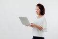 Asian beautiful woman Standing in a white shirt in her hand Holding a laptop computer Stand smiling happily With a white Royalty Free Stock Photo