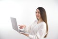 Asian beautiful woman Standing in a white shirt in her hand Holding a laptop computer Stand smiling happily With a white Royalty Free Stock Photo