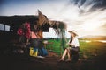 Asian Beautiful woman in Thai local dress sitting and working with fishing net in fishing village with field and lake Royalty Free Stock Photo