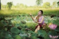 Asian beautiful woman walking in lotus field.