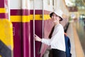 Asian beautiful woman was walking onto the train to travel while the train was parked at the platform