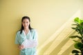 Asian beautiful women patients standing on yellow background,Happy and smiling,Good attitude,Insurance policy concept,Copy space f Royalty Free Stock Photo