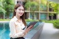 Asian beautiful working female uses tablet to search data in working from anywhere concept