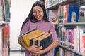 Asian beautiful young woman student holding stack of old books i Royalty Free Stock Photo