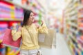 Asian beauty girl is happiness with paper bags on blurred alley store