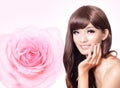 Asian beauty hand touch face with pink rose Royalty Free Stock Photo